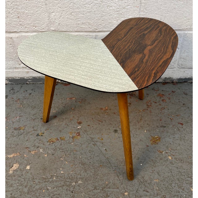 Add a touch of retro charm to your space with this eye-catching mid-century modern coffee table. Featuring a unique...