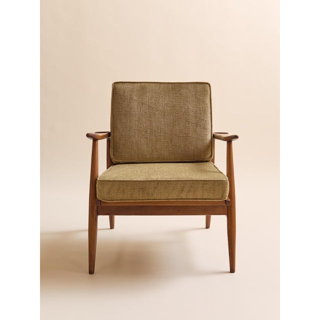 A beautifully proportioned Mid-Century Modern lounge chair featuring a sculptural exposed teak frame and refined tapered...