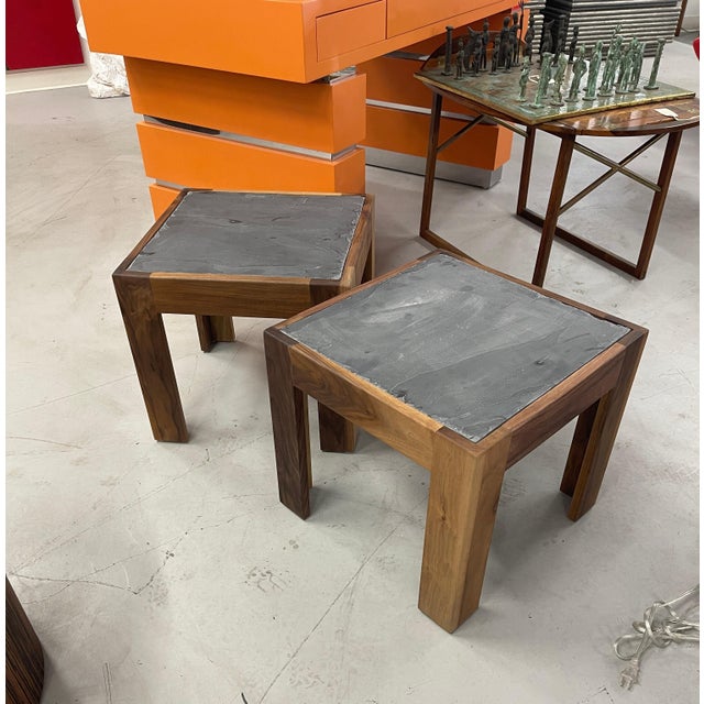 A pair of solid walnut tables with slate inset tops. Beautiful graining to the walnut sides. These are custom pieces newly...
