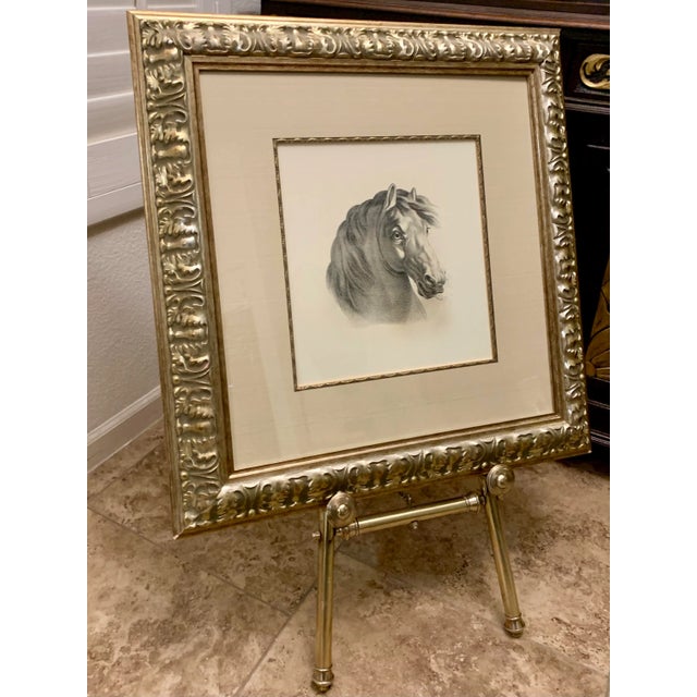 A beautifully framed Print of a horse. Created, framed and purchased in Brazil. Sits on an Vintage brass easel that has...
