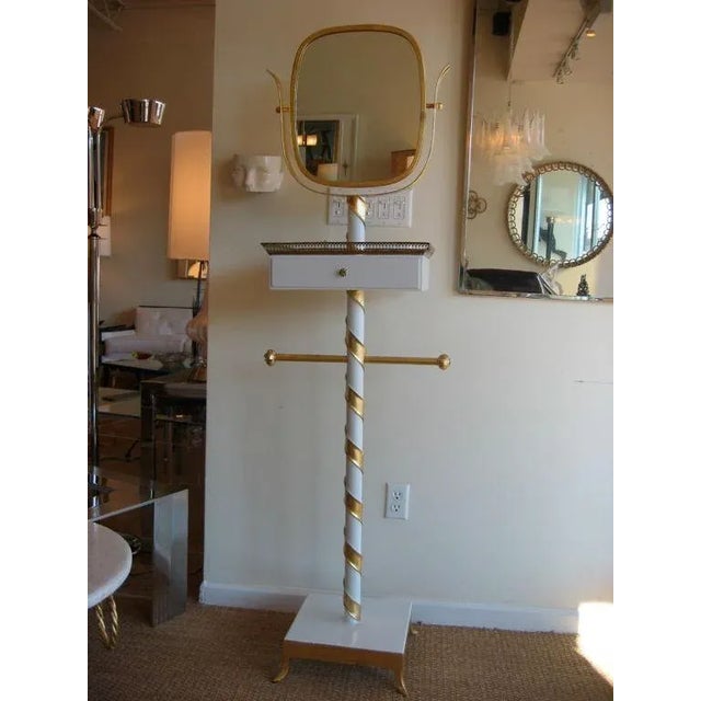 Is it a valet? Is it a stand? Is it a piece of art? Only one who looks in will see. This fabulous signed vintage Italian...