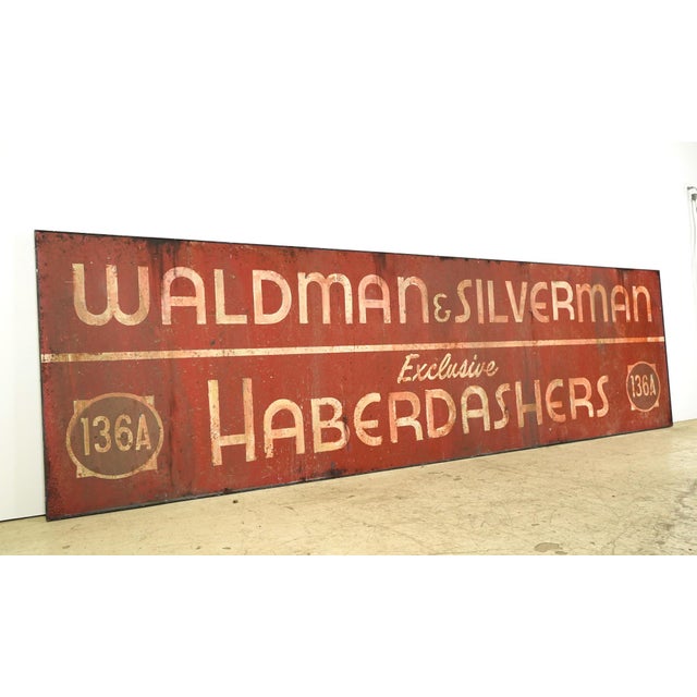 Reclaimed movie set sign made of aluminum in white, red, and tan colors. The sign reads "Waldman & Silverman, Exclusive...