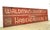 Reclaimed movie set sign made of aluminum in white, red, and tan colors. The sign reads "Waldman & Silverman, Exclusive...