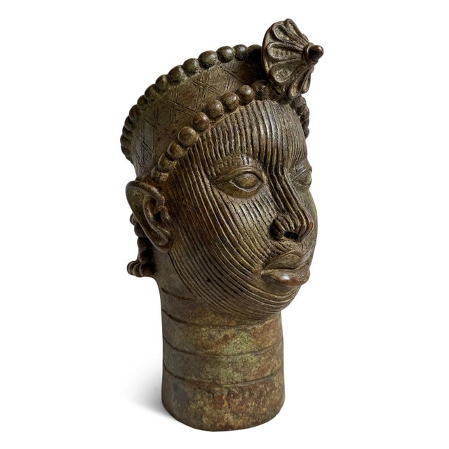 Striking Edo-Ife bronze sculptural head vessel from Nigeria, notable for its near life-size presence. This piece reflects...