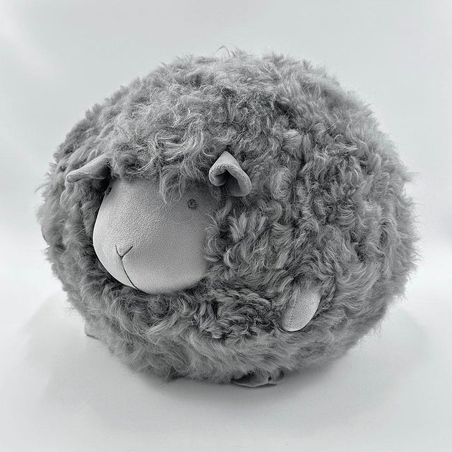 Beyond its irresistibly cuddly charm! This gray plush sheep adds a touch of whimsy to any space—perfect for a nursery, a...