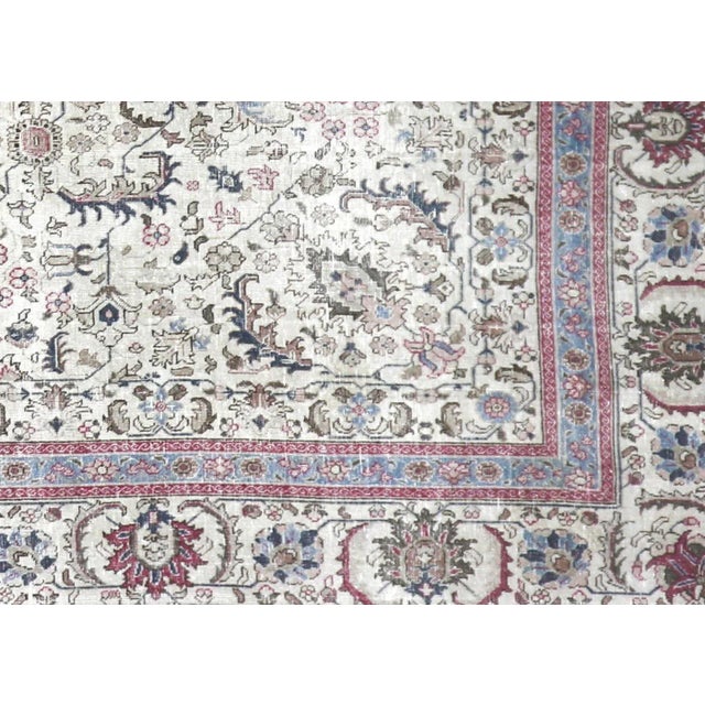 1940s Persian Tabriz Rug. Hand woven in the Tabriz region of Northern Iran. Distressed and refinished in the U.S. The...
