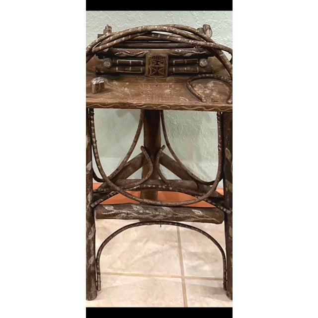 Late 19th-century American Folk Art Adirondack twig table integrating a miniature tramp art log cabin, constructed...