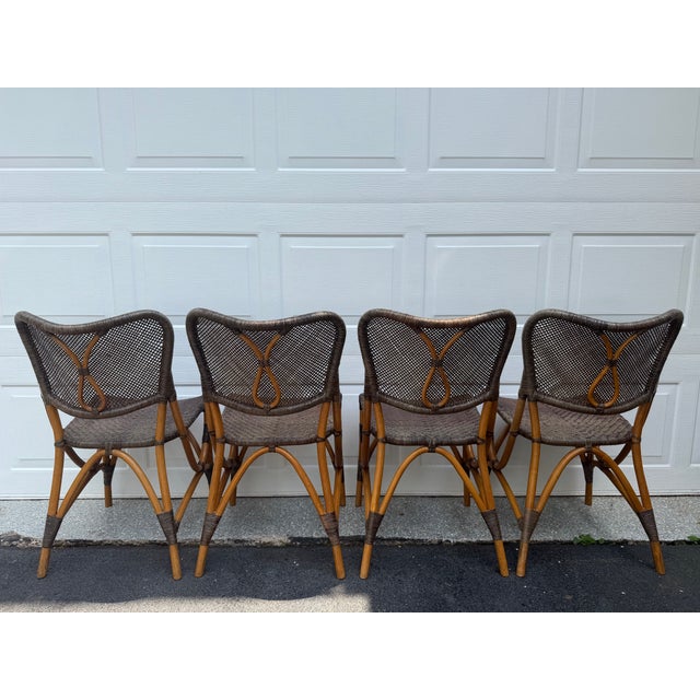 Set of four bentwood dining chairs (similar to bistro or cafe style) with woven rattan and cane seats and backs. I do not...