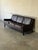 This three-seater sofa features a streamlined silhouette with subtly flared arms and plush removable cushions. It rests on...