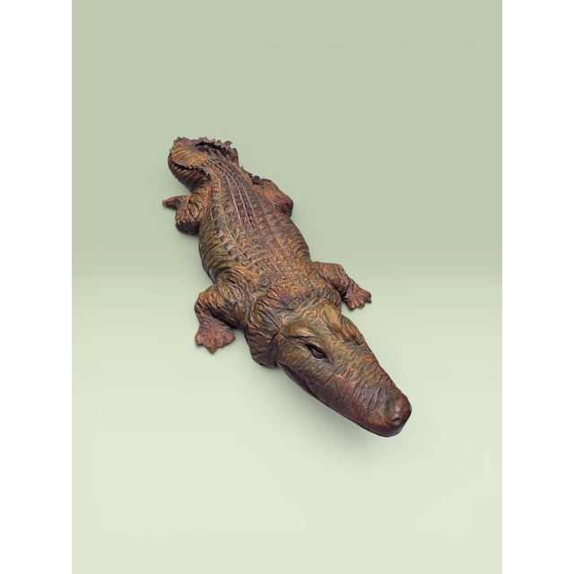 A monumental hand-carved solid wood alligator sculpture by acclaimed American chainsaw artist Ken Packie of Berkshire...