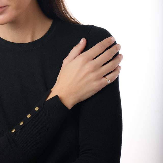 This elegant vintage engagement ring captures the timeless beauty of classic design through the luminous presence of its...