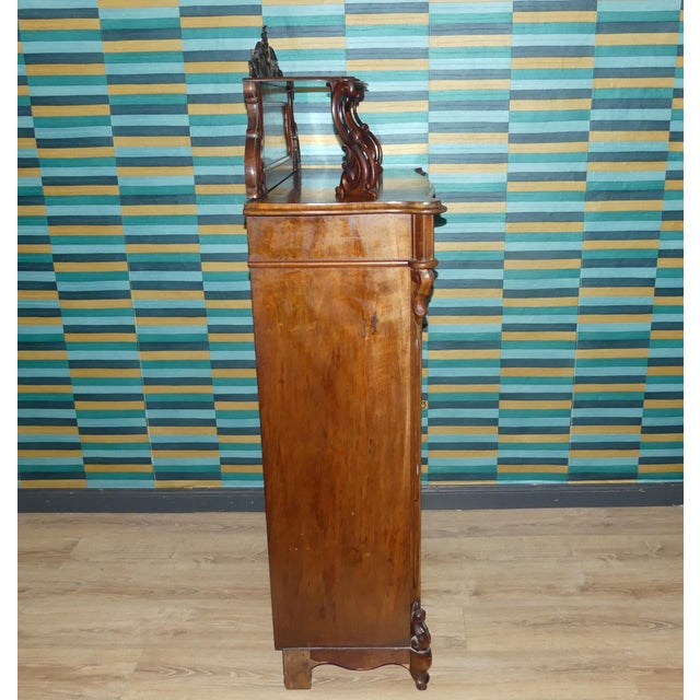 Elegant antique cabinet! The lower section is a fairly straightforward cabinet with subtle decorative carvings, featuring...