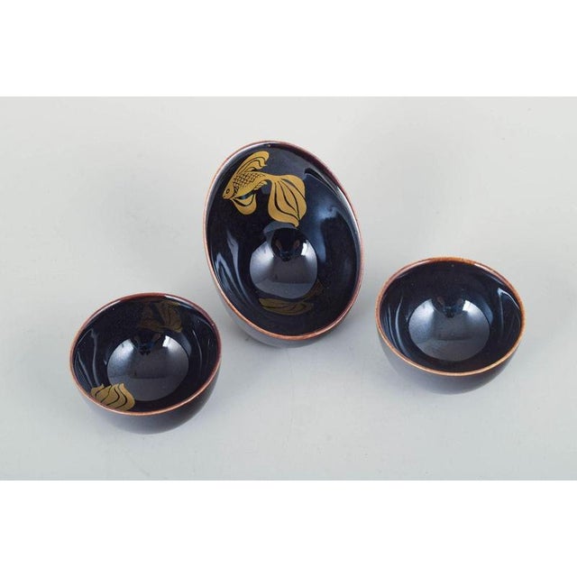 Gustavsberg Set of Three Miniature Bowls, Mid-20th Century. Three small hand-glazed bowls in deep blue glaze, one...