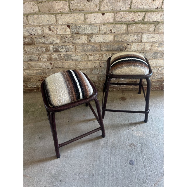 Pair of industrial metal stools from Portugal. These stools have been newly reupholstered in a vintage striped Alpaca...