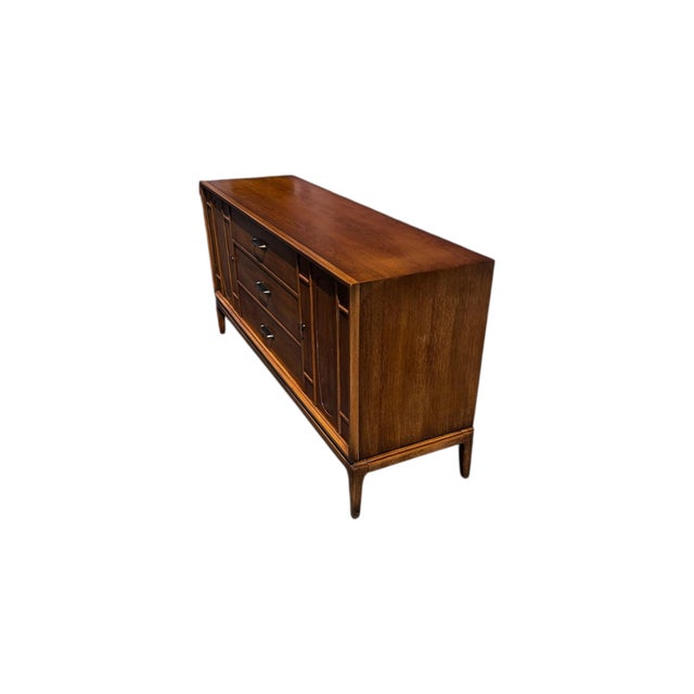 This vintage Mid Century Modern credenza by the Halle Bros, showcases clean architectural lines paired with the warmth of...