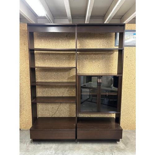 Impressive large-scale wall unit in dark stained wood with a strong architectural presence. This modular shelving system...