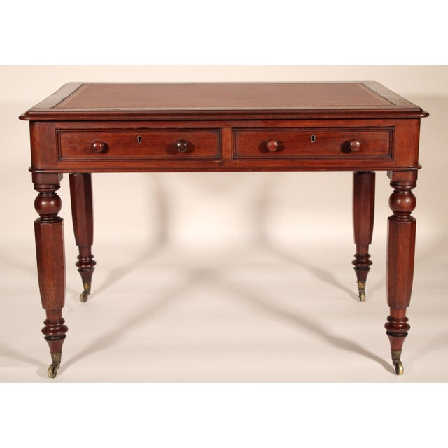 William IV mahogany writing table with a tooled leather top, circa 1835. With a rectangular top with rounded corners, an...