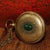 Solid brass pocket compass combining sundial and compass functions, engraved with directional markings and vintage London...