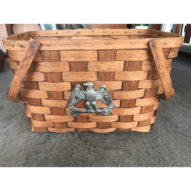 This is a great organizational and decorative basket with split wood that is woven with 2 handles. There is an eagle...