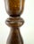 A pair of vintage turned wood candlesticks showcasing classic proportions and a warm walnut-toned finish that highlights...