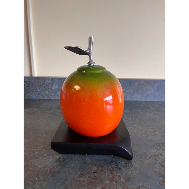 A fun pop art style sculpture of a multicolored apple on black wood base. The apple is made of solid turned wood and shows...
