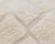 Soft squares of light: a checkerboard sculpted in pure ivory wool. A tone-on-tone checkerboard covers the rug, formed by...