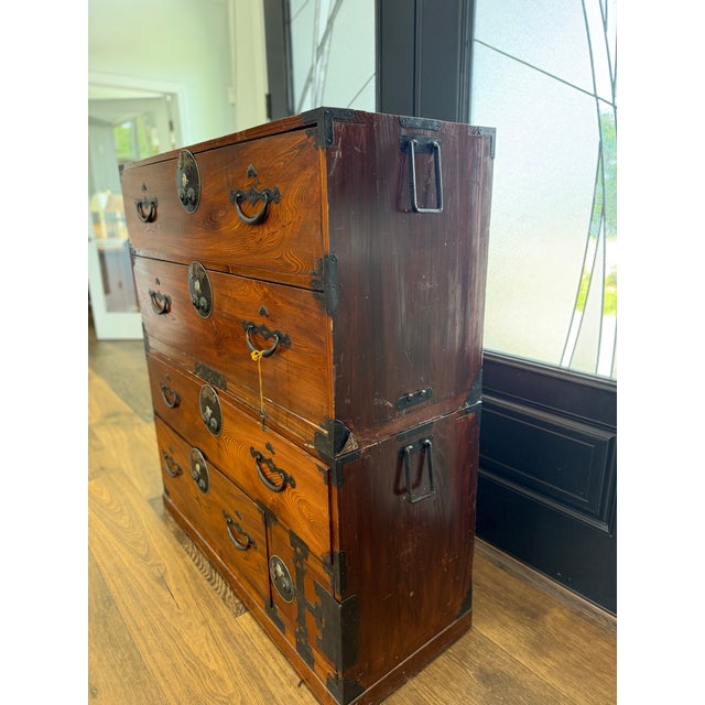 A remarkable and highly decorative Japanese Meiji Period stacking tansu chest crafted from richly figured keyaki (Japanese...