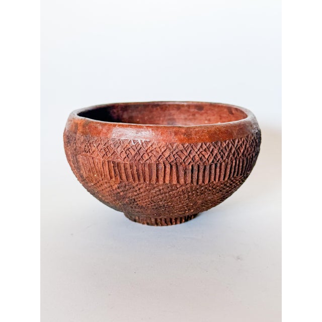 Very cool handmade carved redware clay bowl in the style of a primitive artifact. Features impressed patterns and hatching...