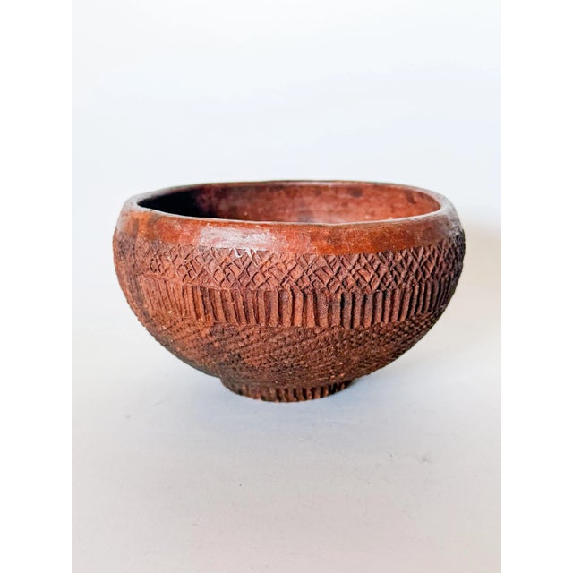 Very cool handmade carved redware clay pottery bowl in the style of a primitive artifact. Features impressed patterns and...