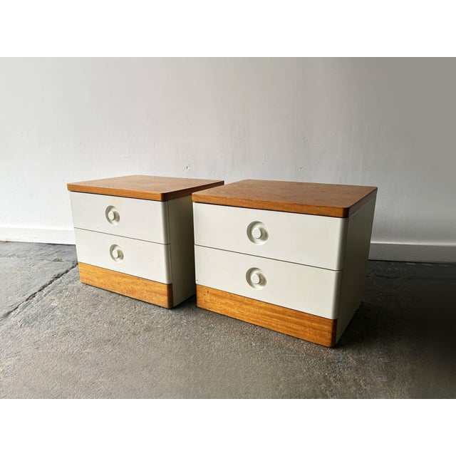 A pair of Mid-Century bedside cabinets by Stag dating from the 1960s. Each cabinet has two drawers with circular recessed...