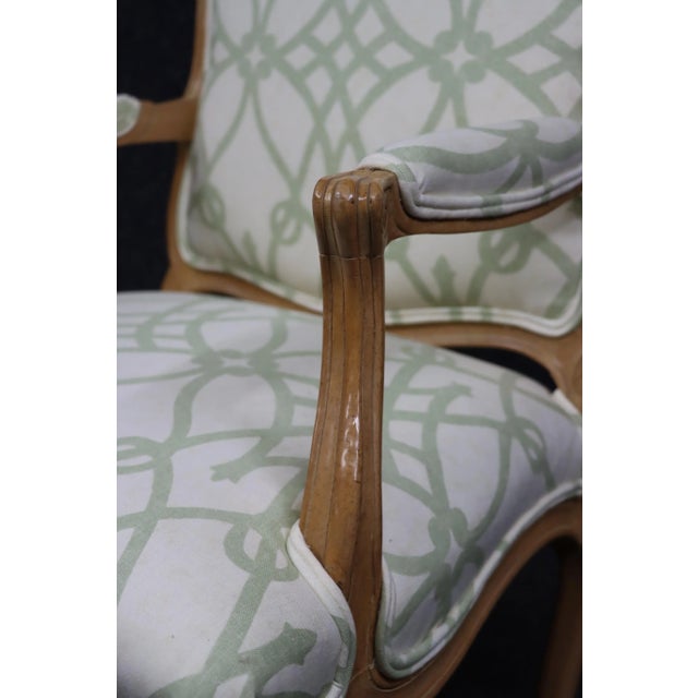 Louis XV style bergere in fruitwood carved frame with white and green upholstery.