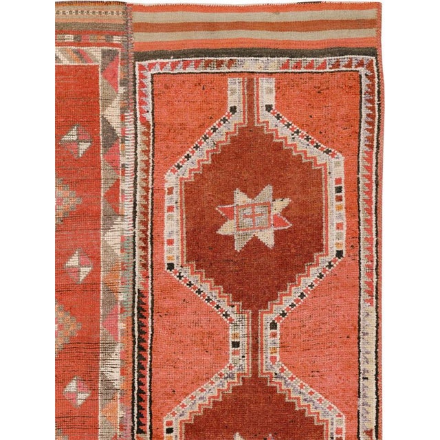 This Mid-20th century Turkish Anatolian room-size carpet presents a tripartite composition assembled from three vertically...