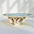 This vintage 1940s Cole Merris bowl features a light blue to celadon glaze and is supported by three applied fruit-and-...