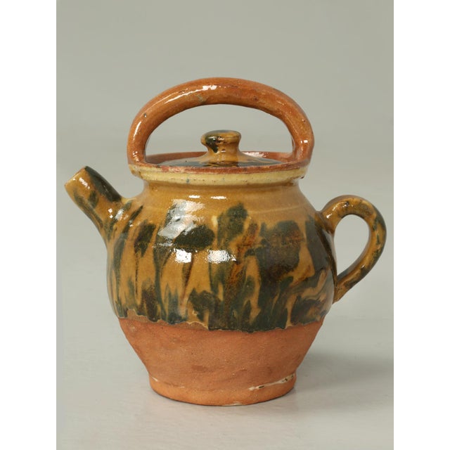 French pottery jug with a non-broken handle and still complete with its original lid. Looks to be circa 1950s and adds a...