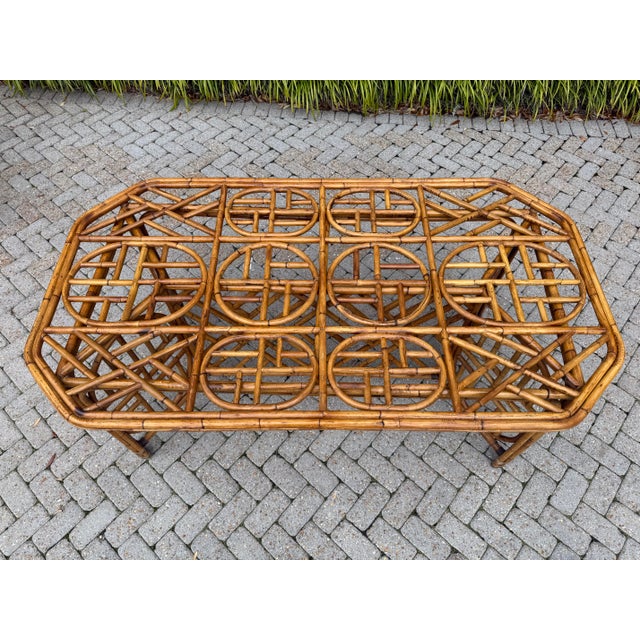 Capture the relaxed elegance of mid-century design with this rare, stunning set of vintage rattan table and chairs....