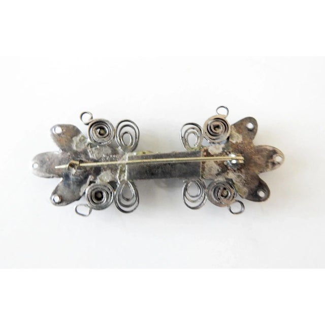 Vintage circa 1960's artist handmade silver and turquoise brooch. Filigree design using silver strips quillwork, bezel set...