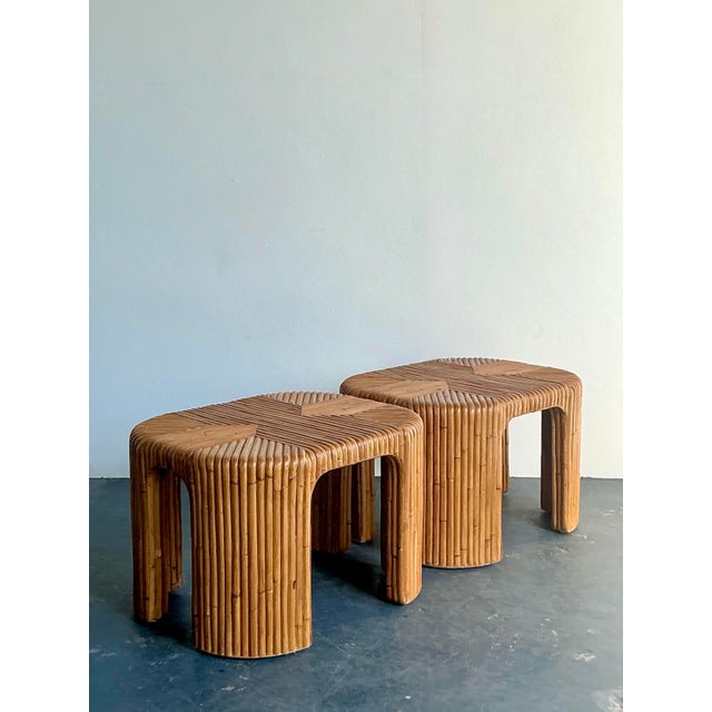 This stunning pair of vintage pencil rattan side tables epitomizes the organic elegance of the 1970s Boho Chic era....