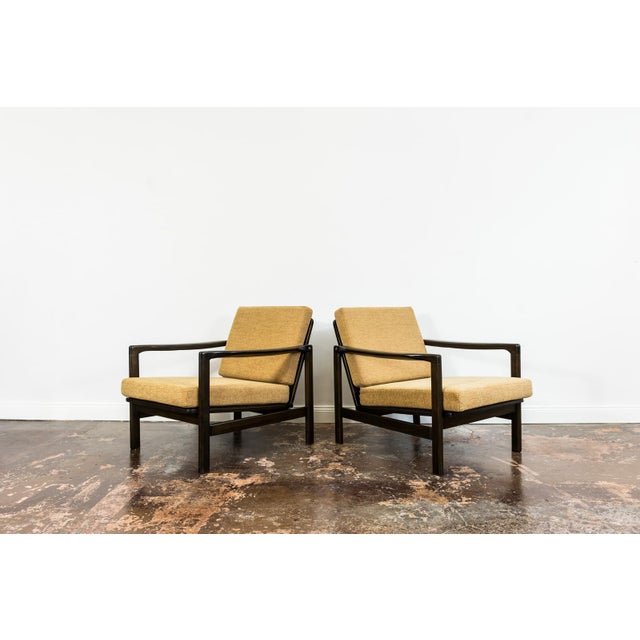 A pair of club chairs "type B7522," designed by Zenon Bączyk and produced in Poland in the 1960s, exemplifies the...