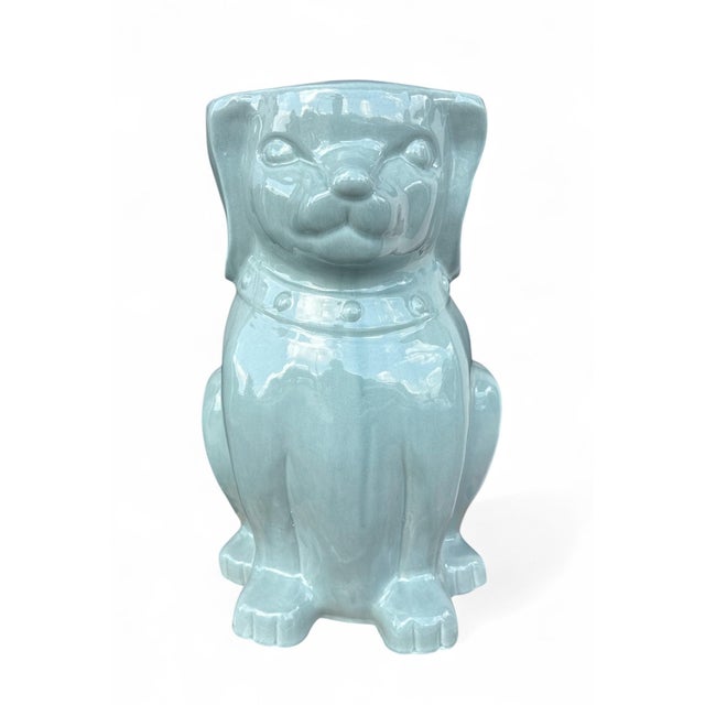 The Foo Dog Garden Stool is a whimsical ceramic garden stool shaped as a seated foo dog (guardian lion) with a flat top,...