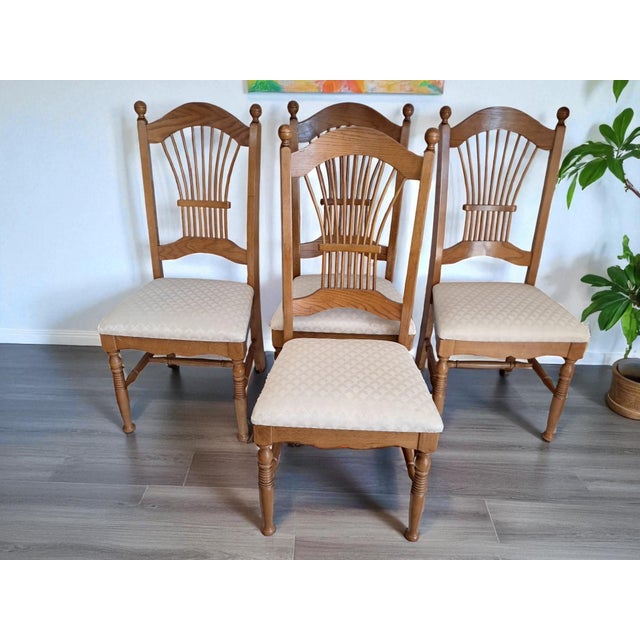 Set of 4 French Country Vintage Oak Dining Chairs dating from the 1980's A charming set of four solid oak dining chairs...