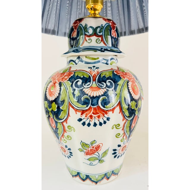 An early 20th century table lamp made from a rare antique lidded vase by royal tichelaar makkum. Decorated on a white...