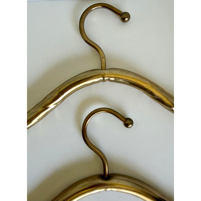 Here is a fabulous pair of vintage gold-plated clothes hangers, attributed to Lee Rowan. Beautifully made with a rich...