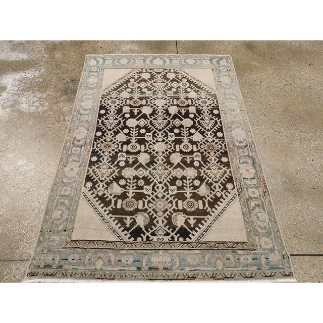 This Mid-20th century Persian Malayer rug, measuring 3' 6" x 5' 1", reflects the refined artistry of village weaving...