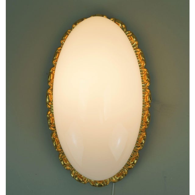 Elegant vintage wall lamp manufactured by limburg during the 1970s or 1980s. Model no. A 234 / 2083. Both the base and the...