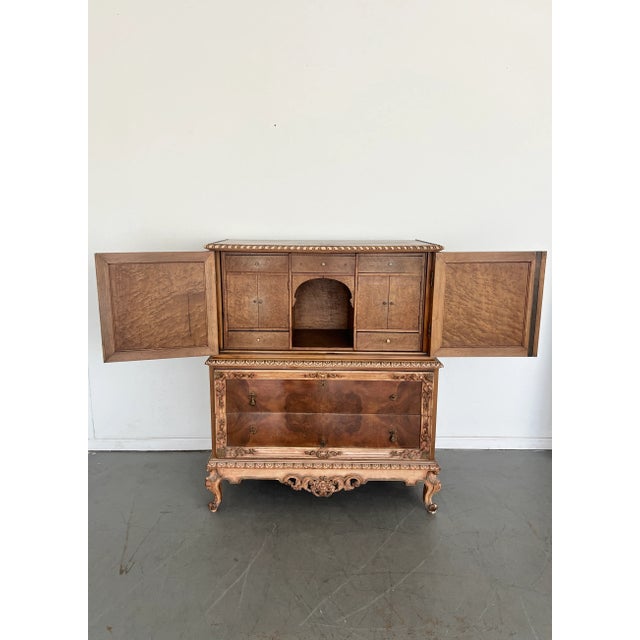 Burl Walnut Armoire with Carved Gilt Trim, Circa 1900s This stately French Rococo Revival tallboy chest combines practical...