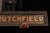 1918 Goodman and Crutchfield Reverse Painted Glass Sign For Sale - Image 4 of 5