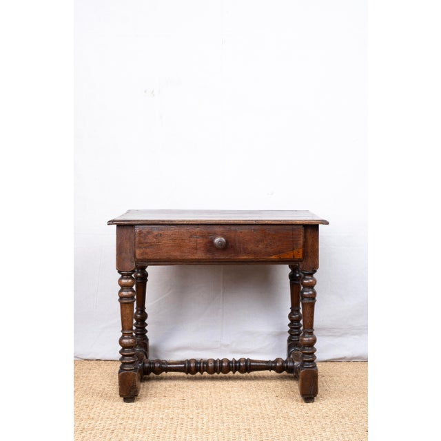An antique side or occasional table, early 18th century, English. Features a single drawer with dovetails joints and...