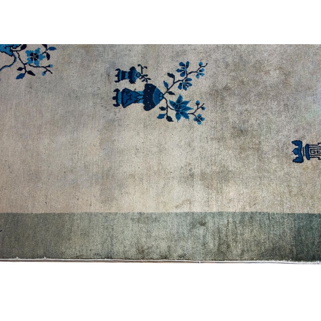 A simple but chic early 20th century Chinese Art Deco rug with a gray central field surrounded by a darker gray border. A...