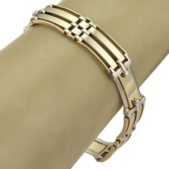 This product is a vintage, original 14k two tone gold fancy gate link bracelet. The bracelet features intricate detailing...