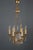 Vintage six arm French Empire brass chandelier, decorated with cristal prisms. The central body of the light has two...